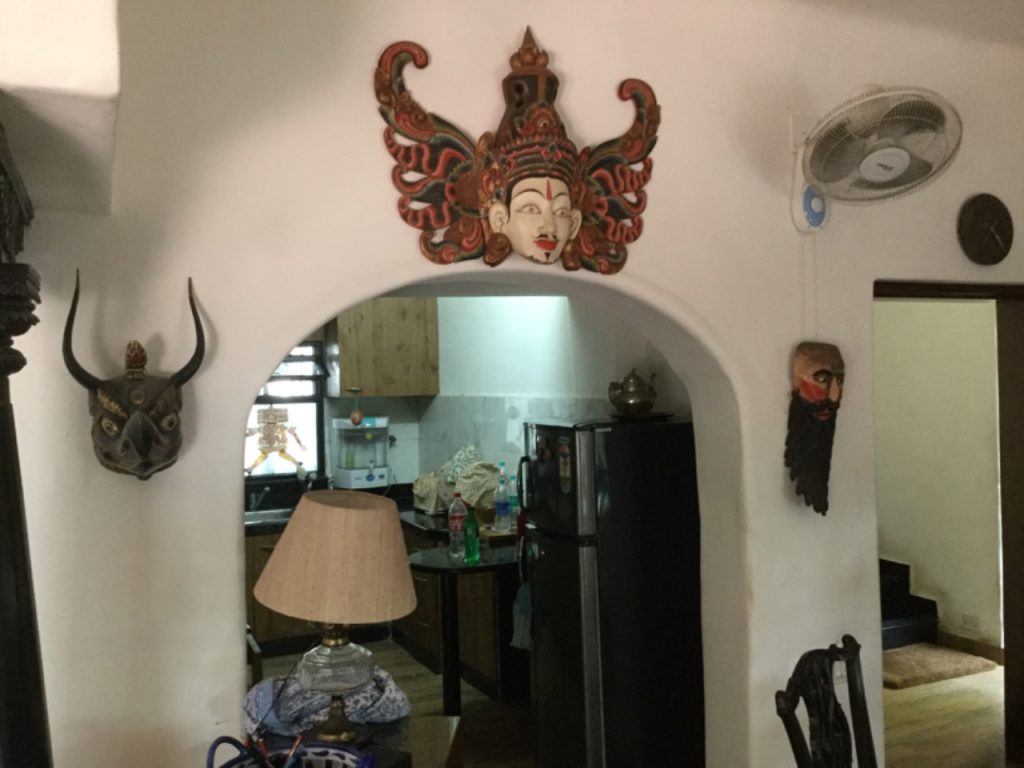 A masked wall hanging adorning the wall